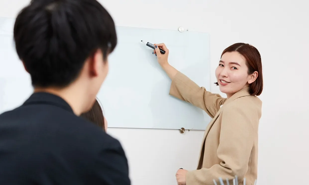 ホワイトボードで説明する女性